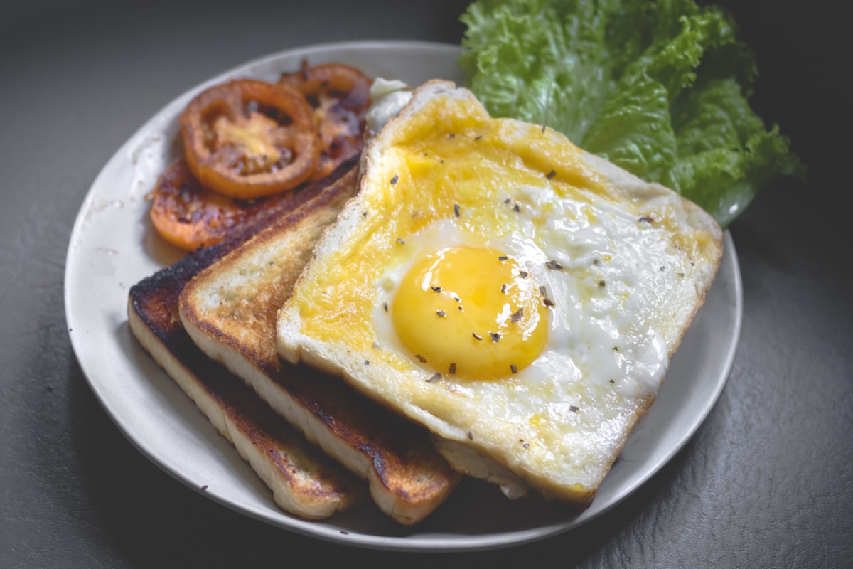 Breakfast for two set by a tall window in morning light